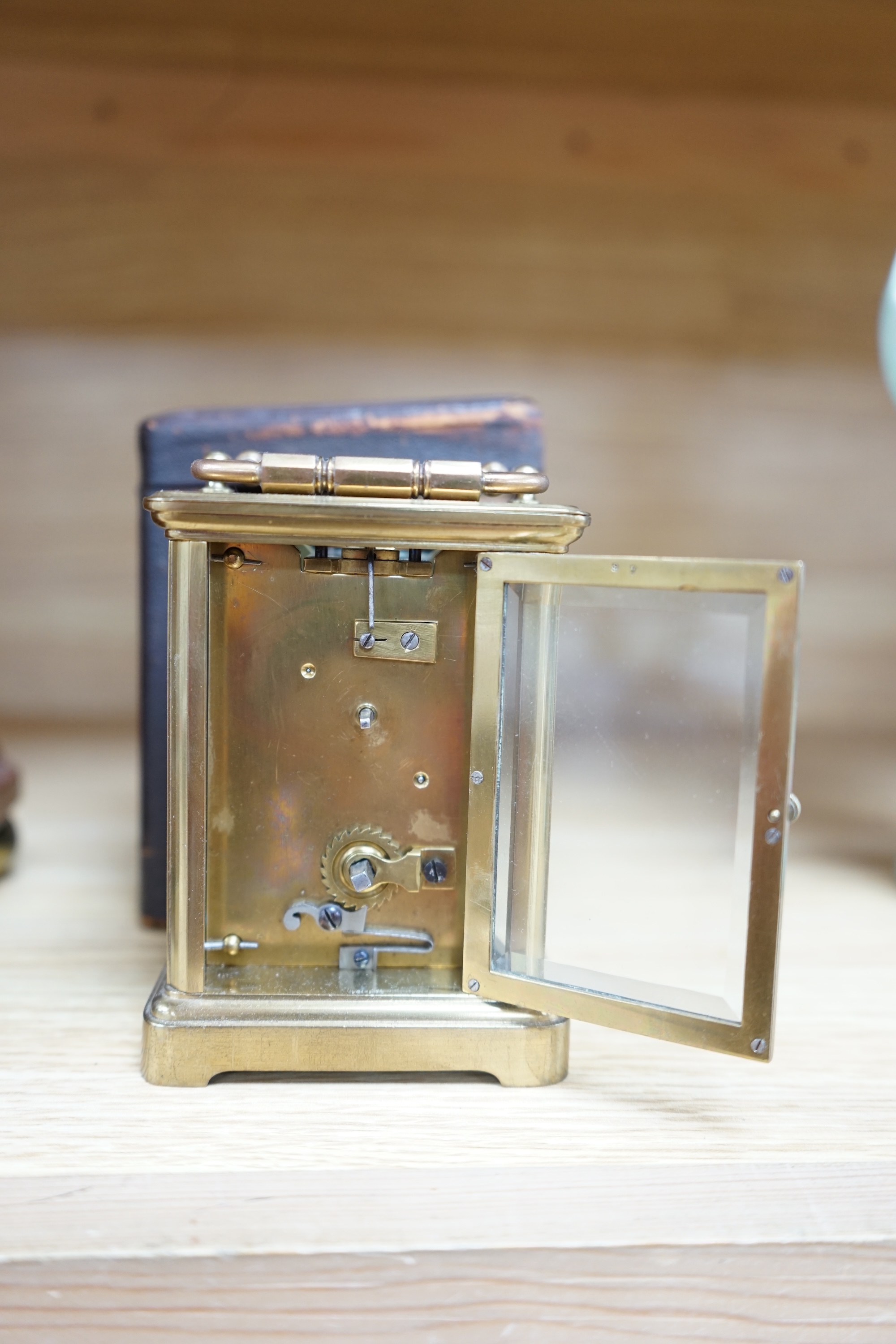 A cased brass carriage timepiece and a dome topped Edwardian mantel clock striking on a coiled gong, backplate stamped BTG, 29.5cm (2) Condition - fair to good.